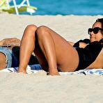 First pic of Christina Milian sunbathing in black swimsuit