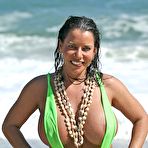 First pic of Alicia DeMarco shows huge boobs in sling bikini playing on beach @ Busty Cafe