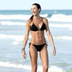 Third pic of Federica Torti yoga in black bikini on a beach