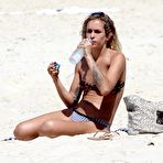 Third pic of Alice Dellal areola slip in bikini on the beach