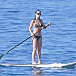 Fourth pic of Olivia Wilde paddle boarding in a bikini at a beach