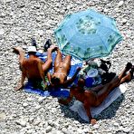 Second pic of Tan-covered nudists enjoy themselves in the sun