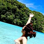Fourth pic of Sexy Japanese girl poses in her colorful bikini at the beach and gets her nice tits and ass all wet.