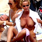 First pic of Federica Mancini sunbathing topless on a beach