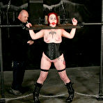 Fourth pic of Tattooed slave girl Alice White in fishnet stockings and boots gets bound and punished