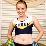First pic of Petite smiling cheerleader Katey Grind gets totally nude and displays her shaved pink pussy