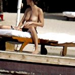 First pic of Karen Mulder relaxing topless on the beach