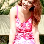 Third pic of Red-haired teen girl Smokie Nubiles in pink dress flashes her nicely trimmed snatch