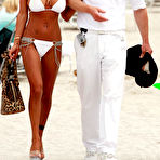 Third pic of Busty supermodel Shauna Sand shows deep cleavage in white bikini on Miami beach