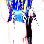 Third pic of Gun girl Jenner Christ with tattoos and piercing poses in blue corset and black boots