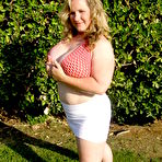 Second pic of Smiling huge titted middle aged fattie Seana Rae in top and skirt poses outdoors