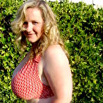 Fourth pic of Smiling huge titted middle aged fattie Seana Rae in top and skirt poses outdoors