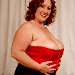 First pic of Redhead plumper Nikki Cars in red corset and white stockings gets her fat pussy banged