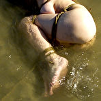 Second pic of Naked juicy titted slave girl Mallory Knots gets hogtied outdoors by the river