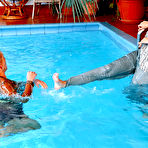 Second pic of Natalli Di Rossa swims in the pool clothed with another lady dressed in satin
