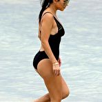 Third pic of Kourtney Kardashian in black swimsuit on a beach
