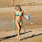 Fourth pic of Stacy Ferguson in geen bikini on a beach