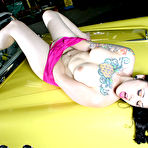 Second pic of Tattooed gothic brunette Nikki 666 strips out of pink of yellow car hood