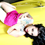 Fourth pic of Tattooed gothic brunette Nikki 666 strips out of pink of yellow car hood