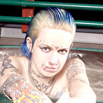 Third pic of Naked alt girl Rachel Face lets you read her tattoos and shows her pierced parts in jacuzzi