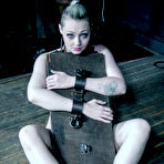 Second pic of SexPreviews - Arielle Aquinas sexy blonde is metal bound on wooden device in kinky dungeon