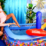 First pic of Blonde Dionne Darling and her brunette friend get in the pool with their pink clothes on
