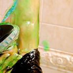Fourth pic of Blonde Dionne Darling takes off her clothes and plays with sticky green goo in the bathtub