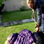 Fourth pic of Shinynylonartsbound | Sophie being tied, gagged and watered with cuffs and a ballgag by Sandra both wearing shiny nylon down jackets and rain pants (Video)