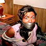 Second pic of tied-and-gagged.com | 27 Yr OLD BEAUTY SALON OWNER IS WRAP TAPE GAGGED, BAREFOOT, TOE-TIED, MOUTH STUFFED WITH THONGS, HANDGAGGED & TIGHTLY TIED ON THE BED (D75-11)