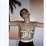 Third pic of Miley Cyrus posing topless but covered