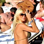 Third pic of Victoria Silvstedt in green bikini on the beach in Caribbean