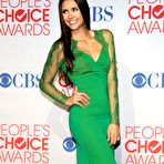 Third pic of Nina Dobrev in green dress posing at 38th People Choice Awards