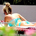 Fourth pic of Ashley Tisdale sunbathing in blue bikini on the beach