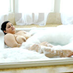 Second pic of Latina BBW Karla Lane relaxing her big juicy ass and large breasts in a soapy tub