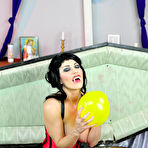 Third pic of Busty Vampire Kymberly Jane popping balloons inside her coffin