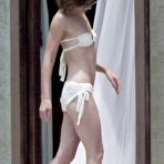 First pic of Milla Jovovich topless but covered on the beach in Los Cabos