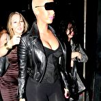 Second pic of Busty Amber Rose in tight clothing shows cleavage and round ass