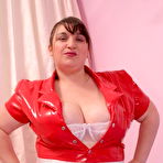 First pic of Plump nurse in red latex plays and oils her monster breasts