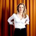 Third pic of Gillian Anderson in white blouse & black trousers