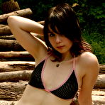 First pic of Ariel Rebel - Ariel Rebel puts on shorts and top to pose on a pile of logs and to show her slit.