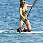 Third pic of Abigail Clancy paddleboarding in green bikini