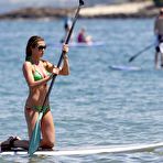 Fourth pic of Abigail Clancy paddleboarding in green bikini