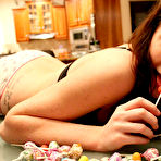 Third pic of Seductive teen brunette girl Freckles is sprawled in the middle of all this candy 