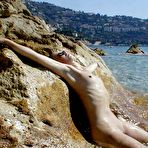 Second pic of Young nudists rub oil on each other's naked bodies