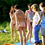 Third pic of Young nudists rub oil on each other's naked bodies