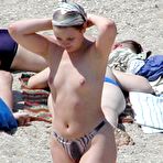 Fourth pic of Young nudists rub oil on each other's naked bodies
