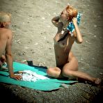 Second pic of Overheated beach nudists sunbathing and feeling up