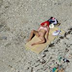 Third pic of Overheated beach nudists sunbathing and feeling up