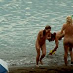 Third pic of Fired up nudists fool around and sunbath on a beach