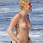 Third pic of Miley Cyrus caught topless on a beach